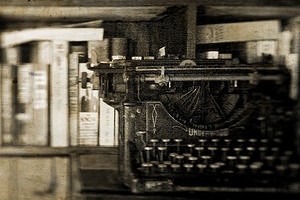 Typewriter and bookshelves in sepia