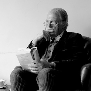 Older man with book, thinking